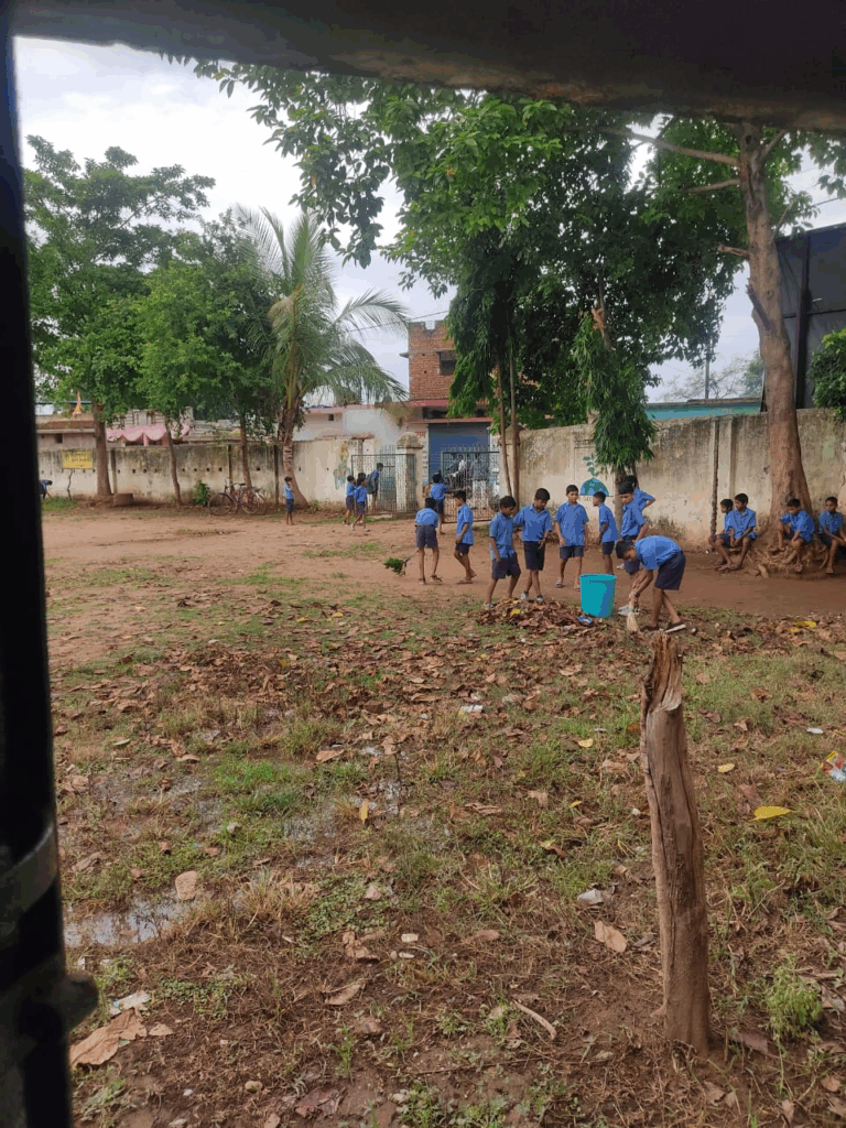 Children sweeping in school