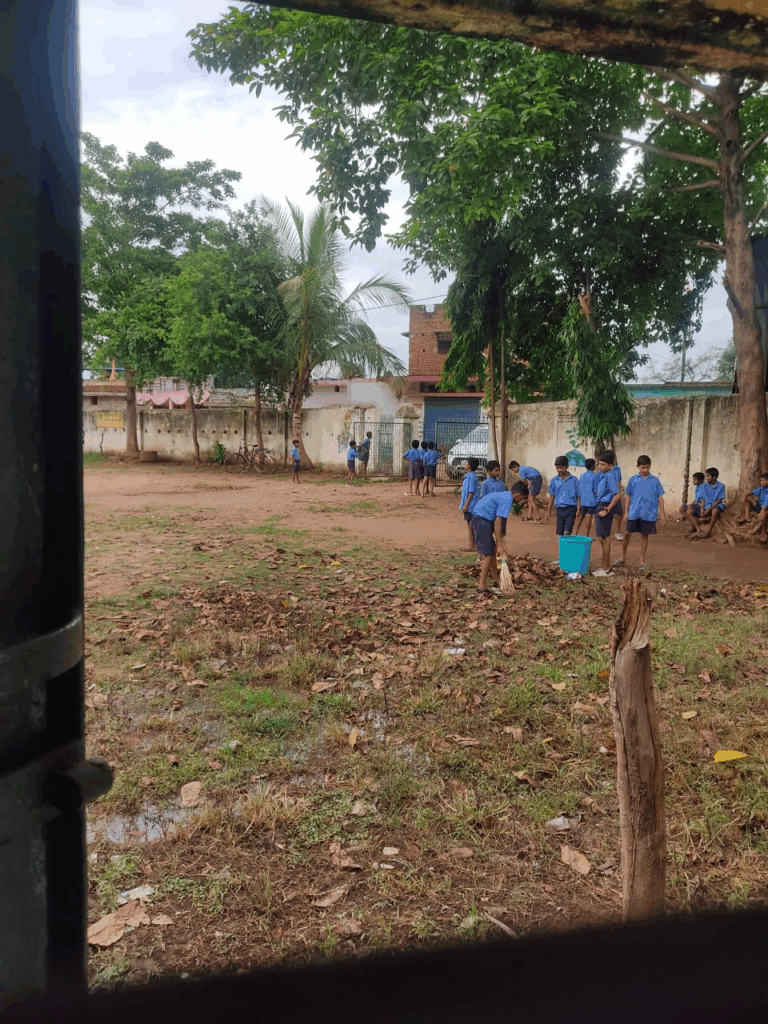 Children sweeping in school